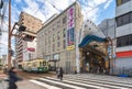 A retro tramway stopped at the entrance of Hamanomachi shopping street shaped as the prow of a ship.