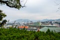Nagasaki landscape view with autumn trees and overcast sky seen from Glover Garden on the hill overlooking the city, Japan