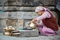 Old Indian woman cleans the dishes