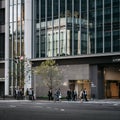 Nagoya, Aichi, Japan - Japanese office workers crossing the road in front of Nagoya Station.