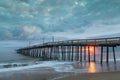 Nags Head Fishing Pier under Thick Storm Clouds at Sunrise NC Royalty Free Stock Photo