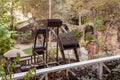 Water mill wheel in the lower yard on exhibition in the Gardens Almona collection, in the rays of the setting sun, in the Druze