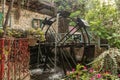 Water mill wheel in the lower yard on exhibition in the Gardens Almona collection, in the rays of the setting sun, in the Druze