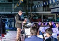 The kapellmeister directs the performance of the city brass band on stage in front of the municipality in honor of the 70th annive Royalty Free Stock Photo