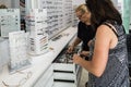 A professional salesperson helps a woman to choose reading glasses in an optometric shop in Nahariyya city in Israel