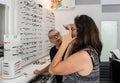 A professional salesperson helps a woman to choose reading glasses in an optometric shop in Nahariyya city in Israel Royalty Free Stock Photo