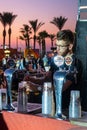 The seller pours beer near the stand of the Israeli beer company Goldstar at the Beer Festival on the promenade of Nahariya city i Royalty Free Stock Photo