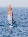 Young athlete in a black tracksuit exercising in windsurfing in the Mediterranean sea in Nahariya, Israel Royalty Free Stock Photo