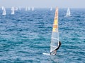 Young athlete in a black tracksuit exercising in windsurfing in the Mediterranean sea in Nahariya, Israel Royalty Free Stock Photo