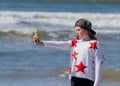 Girl stands on the beach and makes selfie using your mobile phone