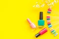 Decorative cosmetics set with flower, nail polish and palette for manicure on yellow background top view space for text Royalty Free Stock Photo