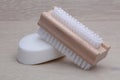 Classic wooden nail brush and soap on wood background