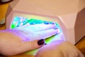 Female hand in UV Gel Acrylic Dryer Royalty Free Stock Photo