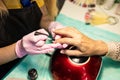 female hands Applying transparent nail polish on healthy natural nails of a woman in a beauty salon Royalty Free Stock Photo