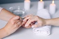 Nail care and manicure. Closeup healthy natural woman`s nails in beauty salon. Manicurist hand paints client`s nails