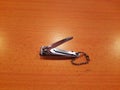 a nail clippers on a brown table Royalty Free Stock Photo