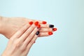 Nail Polish. Art Manicure. Modern style red black Nail Polish with triangle Eiffel tour on it . Beauty hands with Stylish Colorful