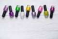 Nail polish bottles in different colors on white wooden background Royalty Free Stock Photo