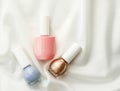 Nail polish bottles on silk background, french manicure products and nailpolish make-up cosmetics for luxury beauty brand and