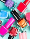 Nail polish colorful bottles. Manicure concept. Top view. Nailpolish colourful bottles over blue background