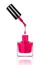 Nail polish dripping from brush into bottle on white Royalty Free Stock Photo