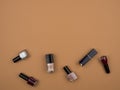 The nail polishes and lipstick . Beige background.