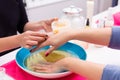 Nail saloon scrub bath exfoliant hands in bowl water Royalty Free Stock Photo