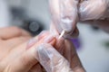 The nail service master does a manicure cleans dirt from under the nails with a wooden stick Royalty Free Stock Photo