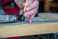 Nail set punch with hammer on wooden board Royalty Free Stock Photo