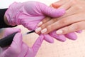 Professional manicurist showing colorful nail polish to check the finish result