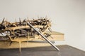 A nail, thorn crown with nail and Bible on a light background