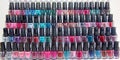 Nail varnishes of various shades and finishes, exhibited on a stand in the form of a backlit disp Royalty Free Stock Photo