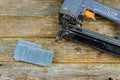 Nail gun and nails on pine wood table