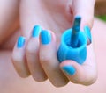 Nails with blue laque covering and brush close up