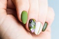 Nails Design. Hands With Bright Green and White Manicure On White Background. Close Up Of Female Hands. Art Nail. Olive manicure Royalty Free Stock Photo