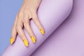 Nails Design. Hands With Bright Yellow Manicure