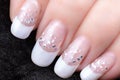 Nails with a French manicure and silver tinsel Royalty Free Stock Photo