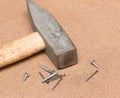 Nails, screws, hammer on a wooden background Royalty Free Stock Photo