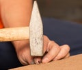 Nails, screws, hammer on a wooden background Royalty Free Stock Photo