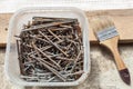 Nails and screws are in the plastic box and brush. Royalty Free Stock Photo