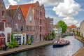 A tour boat sails through the canals of Schiedam, Zuig-Holland, Netherlands. Royalty Free Stock Photo