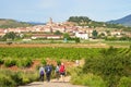 Najera, Spain - July 2019: A group of four pilgrim girls walking the way of Santiago approach the small town of Najera in the