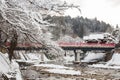 Nakabashi Bridge with snow fall and Miyakawa river in winter season . Landmark of Hida , Gifu , Takayama , Japan . Landscape view