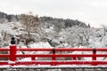 Nakabashi Bridge with snow fall and Miyakawa river in winter season . Landmark of Hida , Gifu , Takayama , Japan . Landscape view