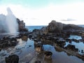 Nakalele Blowhole with water spraying out that was created from Pacific Ocean waves hitting the tall rocky cliff coastline that wa Royalty Free Stock Photo