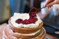 Naked cake hand toping whipped cream berries strawberry cooked birthday wedding homemade Royalty Free Stock Photo