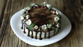 Naked drip cake with chocolate, decorated with strawberries, jasmine flowers and honeysuckle on brown wooden table Royalty Free Stock Photo