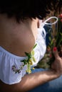 Naked female shoulder with moles decorated with a small bouquet