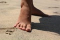 Naked feminine feet on a tropical sandy beach. Nusa Penida. Indonesia