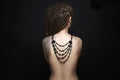 Naked Girl with tattoo and necklace on her back Royalty Free Stock Photo